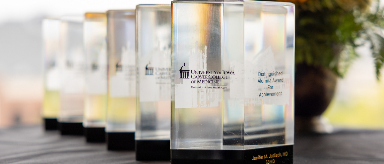A line of alumni awards on a table